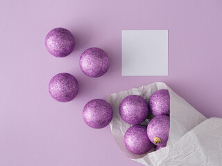 Purple glitter Christmas balls with copy space. Flat lay, top view. Christmas, winter, new year concept.