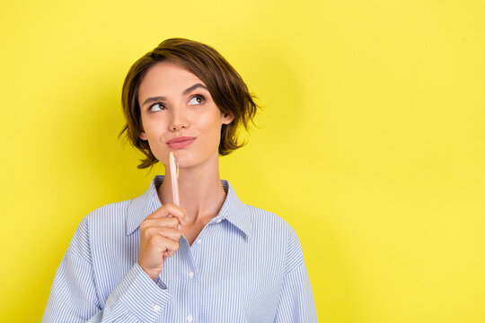 Photo of young woman happy positive smile thoughtful writer idea imagination isolated over yellow color background