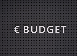 Word Budget with euro symbol spelled out with white letters on gray pegboard