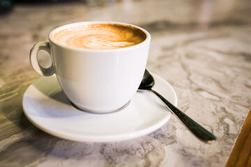 Cup of cappuccino served in restaurant