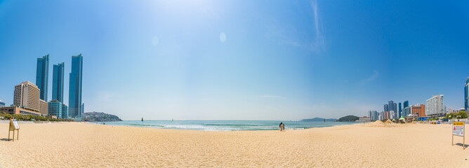 Panoramic shot of a sunny beach and East Sea from Haeundae-gu in Busan, South Korea on a sunny day