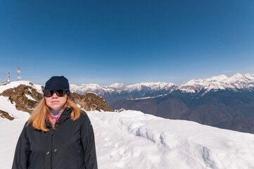 Fototapeta na wymiar redhead girl in snowy mountains