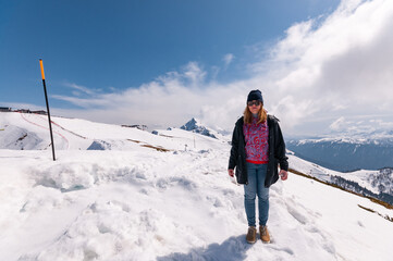 Fototapeta na wymiar redhead girl in snowy mountains