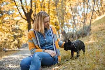 Closeup on happy young woman with dog outdoors in autumn