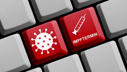 Coronavirus Symbol und Spritze auf roter Computer Tastatur: Impftermin