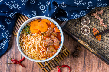 A bowl of braised beef noodles in a tray