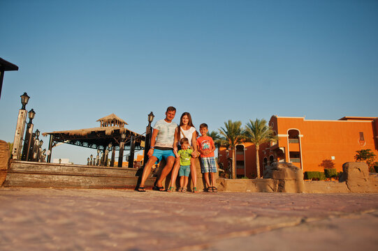 Family On Egyptian Resort In Sunset. Time For Vacation.