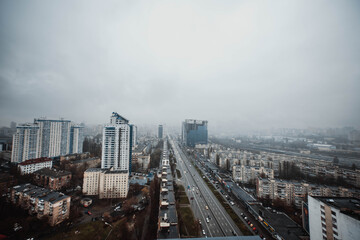 Fototapeta na wymiar High angle view of the city in blue twilight. Dramatic dark thundercloud, rain clouds cover the city. View of the city of Kiev. Ukraine. Abstract. Blurring.