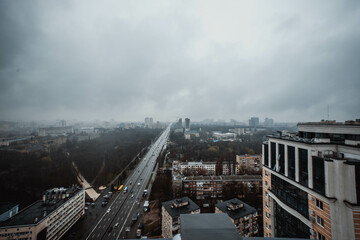 Fototapeta na wymiar High angle view of the city in blue twilight. Dramatic dark thundercloud, rain clouds cover the city. View of the city of Kiev. Ukraine. Abstract. Blurring.
