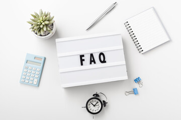 FAQ word on lightbox on white desk, frequently asked questions concept