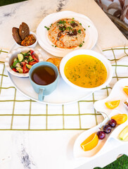 top view soup with chicken broth, tortillas and salad.