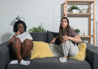 Two young college lesbian biracial couple in relationship African American and caucasian women argue in their home about spending money for rent on the night life and parties