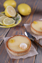 Lemon tartlets, lemons and varente in a glass jar