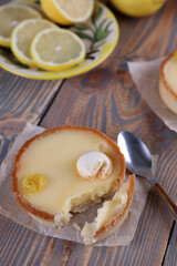 Lemon tartlets, lemons and varente in a glass jar