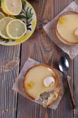 Lemon tartlets, lemons and varente in a glass jar