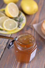 Lemon jam in a glass jar and other lemon desserts