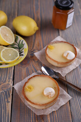 Lemon tartlets, lemons and varente in a glass jar