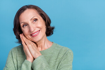 Photo of aged grey hair cute lady look advert wear green jumper isolated on blue color background