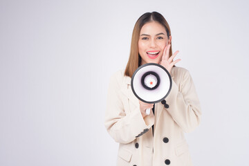 Fototapeta premium portrait of young beautiful smiling woman in suit using megaphone to announce over isolated white background studio..