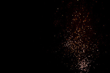 Fototapeta na wymiar Golden abstract bokeh on black background.