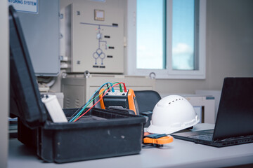 Safety helmet with the solar panel performance check tool and notebook put on the working table of...