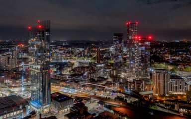 Deansgate Square and Manchester England, modern tower block skyscrapers dominating the Manchester city centre landscape taken at night,. Aerial view of the city lights