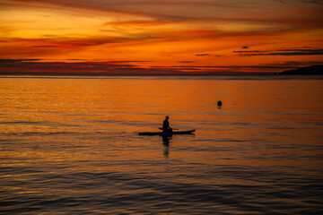 Sunset over wooden beach bar in sea and hut on pier in koh Mak island, Trat, Thailand