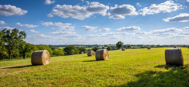 Paysage de campagne et meule de foin au milieu des champs au printemps.