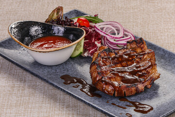 Grilled pork steak with tomato sauce