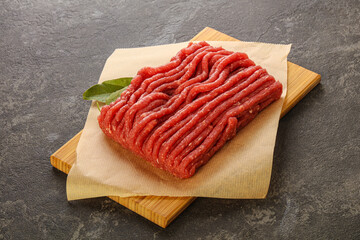 Raw beef minced meat over board