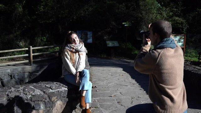 Professional photographer working with a model in autumn.