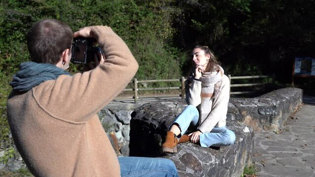 Pretty model wearing winter clothes posing to a professional photographer