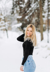 Fototapeta na wymiar Close-up winter portrait of young woman with blond hair in the park