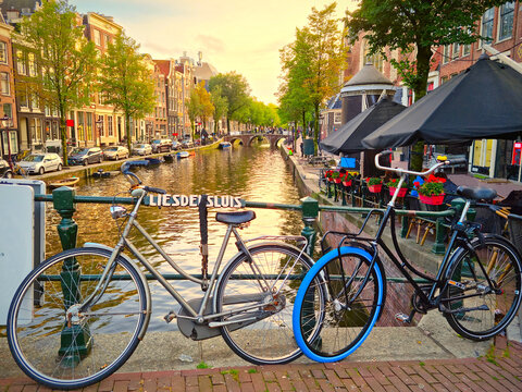 Amsterdam canal and bikes during a sunset