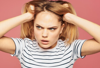 blonde woman in a striped T-shirt discontent upset studio emotions