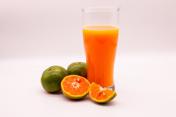 Obraz na płótnie Canvas Still, Life Glass of Fresh Orange Juice and slice fruits isolated on white background. 100 % Orange juice. Tangerines.