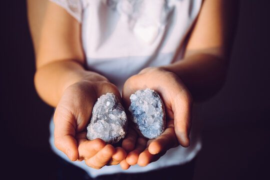 Young 7 Year Old Girl Child Holding Clusters Of Blue Crystals Called Celestite. An Indigo Child Concept, New Age Term.