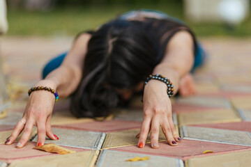 beautiful young girl doing yoga stretching in the park