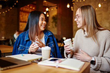 Smiling women spending time in cafeteria