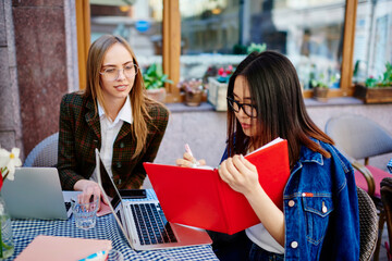 Focused female freelancers working on project together