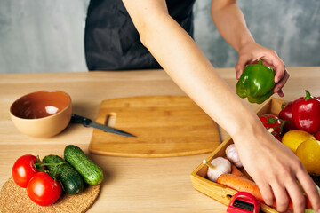Woman in black apron lunch at home vegetarian food