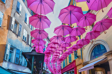 Pink umbrellas decorating the streets of Grasse, Cote d'Azur, France