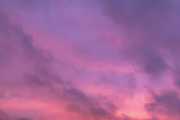 Pink purple twilight sky with dark light clouds