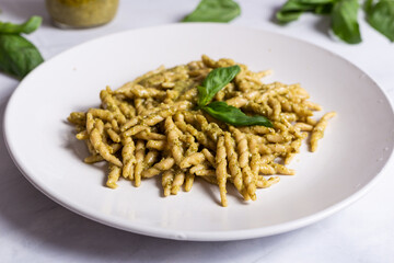 Trofie with pesto, Italian pasta with basil sauce. Pasta with pesto on a white background