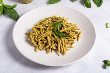 Trofie with pesto, Italian pasta with basil sauce. Pasta with pesto on a white background