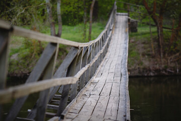 Wooden suspension bridge over the river