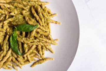 Trofie with pesto, Italian pasta with basil sauce. Pasta with pesto on a white background