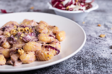 Vegan potato gnocchi with walnut and radicchio sauce - obrazy, fototapety, plakaty