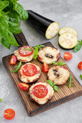 Eggplant pizza with tomatoes sauce, mozzarella, mushrooms and fresh basil. Vegetarian dish. Selective focus