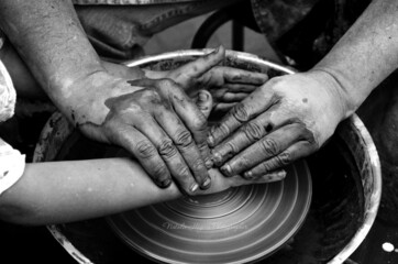 clay molding, hands and clay in the process